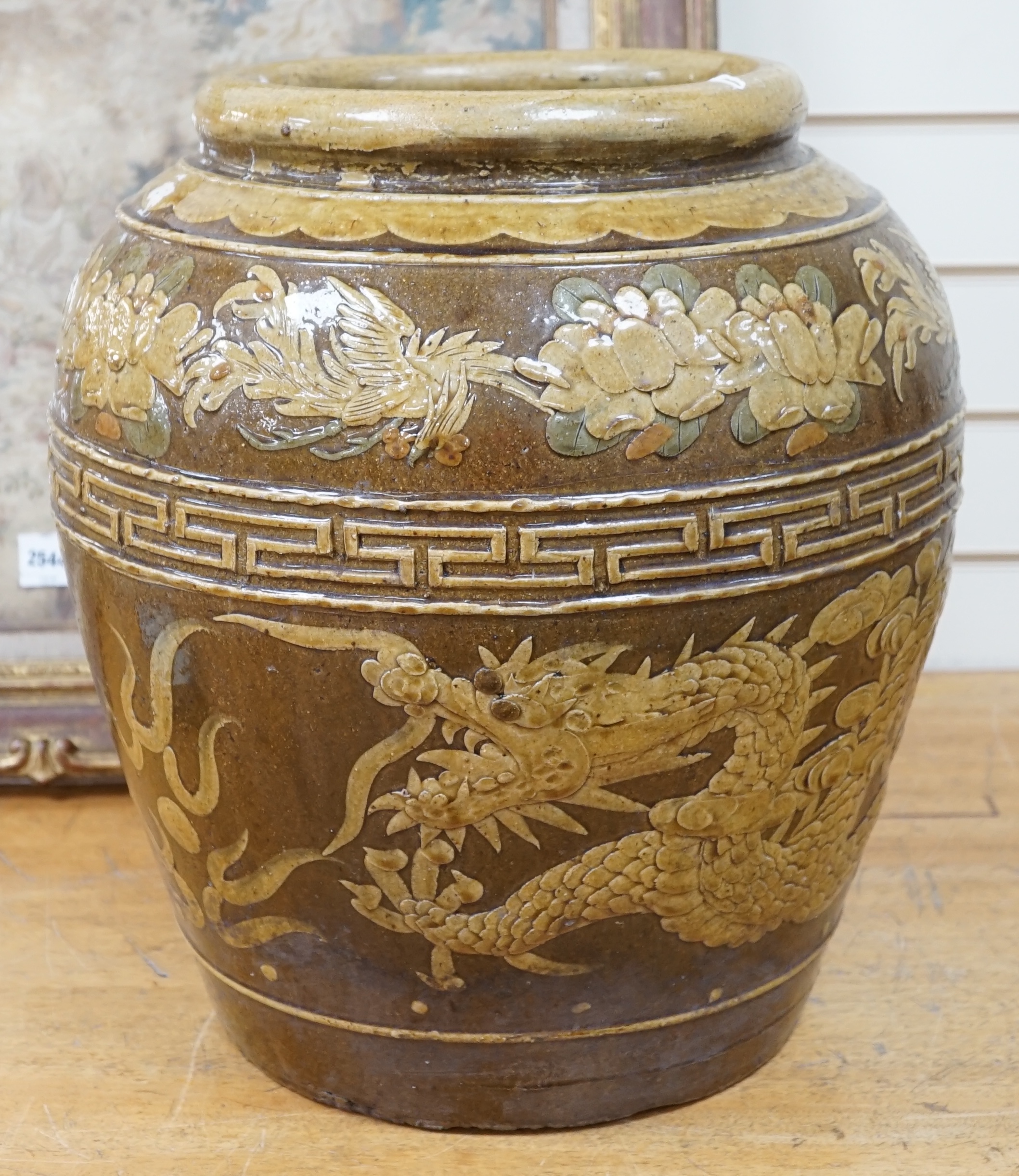 A large Chinese slip decorated ‘dragon and phoenix’ martaban vessel, decorated in relief, 47cm high